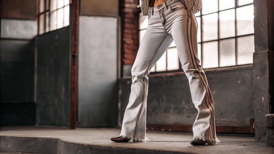 A photo of a pop star from the 2000s wearing [low-rise jeans](https://diznewjeans.com/how-to-make-low-rise-jeans/)[^6] with subtle, manufactured distressing