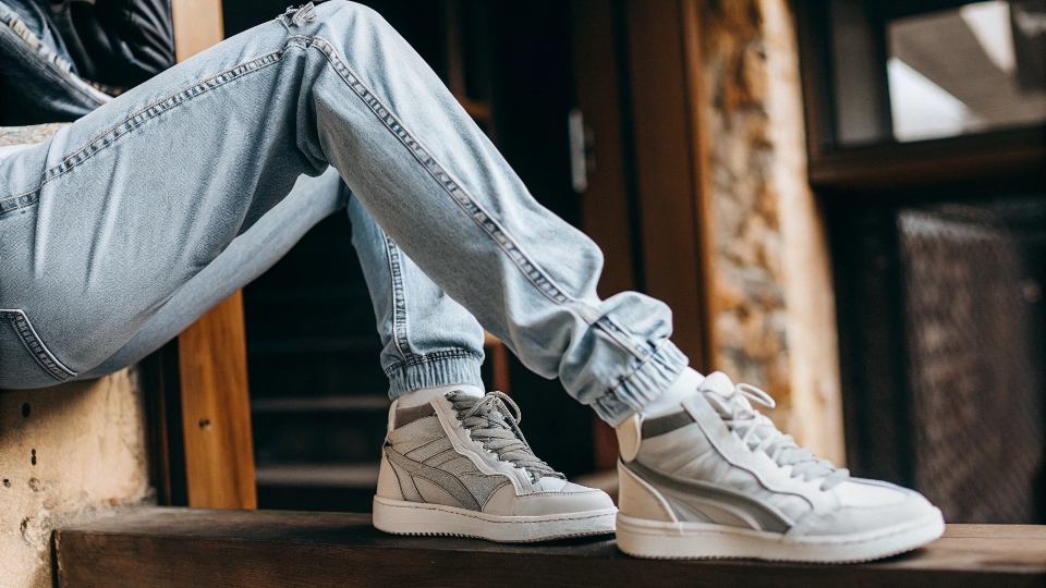 Puma Brand Jeans in a Fashion Shoot A model wearing a pair of Puma collaboration jeans with a stylish sneaker