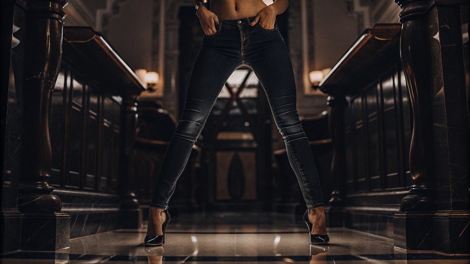 A high-fashion shot of a model wearing True Religion jeans in a stylish setting