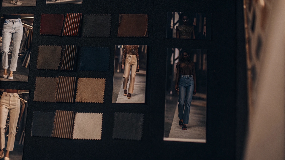 Seasonal Color Forecasting for Denim Fashion A mood board showing fabric swatches in trendy colors, sketches of jeans, and fashion runway photos.