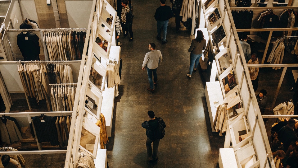 Planning a Sourcing Trip to a China Trade Show An overhead view of a busy trade show floor filled with attendees and booths for the apparel industry.
