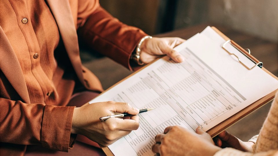 Reviewing a Social Responsibility Audit Report A person reviewing a detailed social responsibility audit report from a third-party auditor like SGS