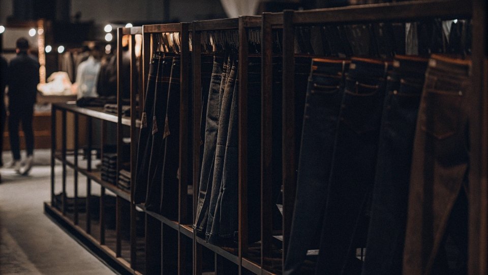 Best Trade Shows for Sourcing Jeans in China A well-designed denim factory booth at the Canton Fair, with jean samples neatly displayed.