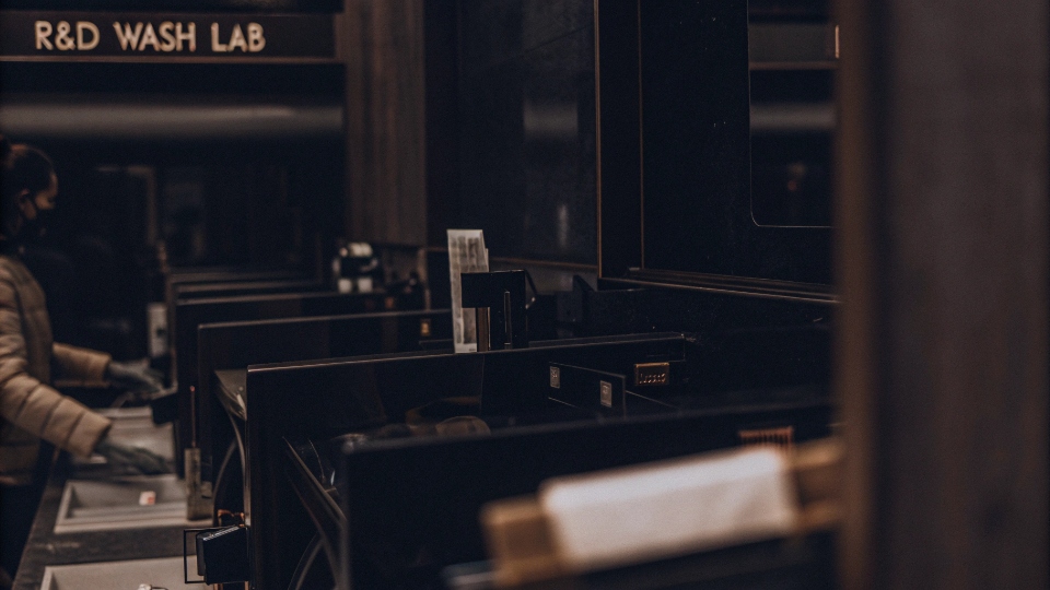 Concurrent Experimental Denim Washes in R&D Lab An R&D wash lab with multiple small-scale washing machines running different tests simultaneously