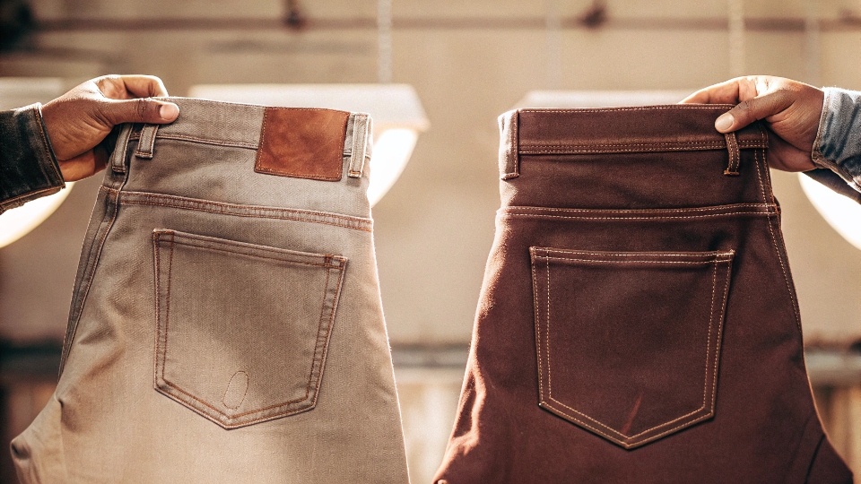 Maintaining Consistent Quality Across Production Sites Two denim back pockets, one from the main factory and one from a partner, held side-by-side to show identical stitching and quality.