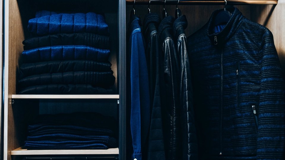 3-3-3 Rule for Clothing Impact on Manufacturing A minimalist closet with a few high-quality items neatly organized.