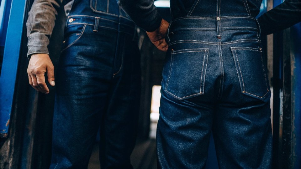 30 Wear Rule as a Quality Standard A person proudly wearing a pair of well-loved jeans, showing character and durability.