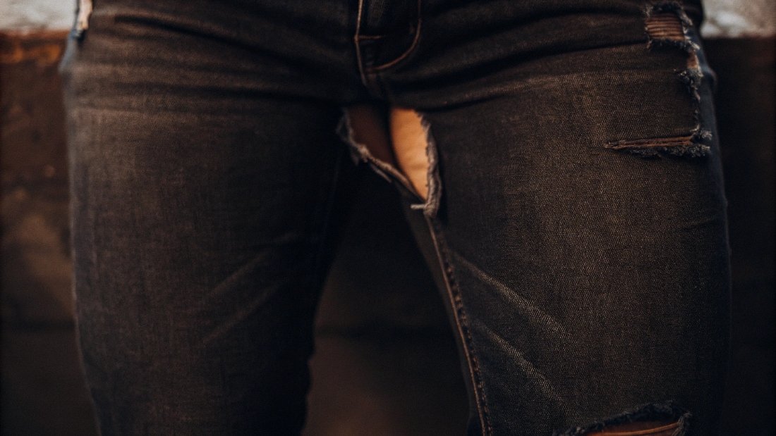 Worn Out Jean Crotch A close-up of a worn-out and frayed crotch area on a pair of denim jeans.