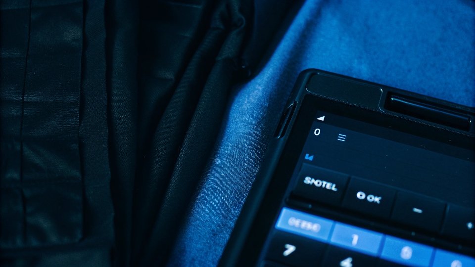 Total Cost to Manufacture Clothing A calculator showing the total landed cost of a clothing order, with invoices for production, shipping, and taxes.