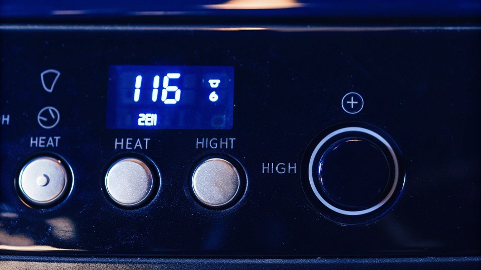 Drying Jeans on High Heat for Permanent Shrinkage A close-up of a dryer's control panel set to high heat.