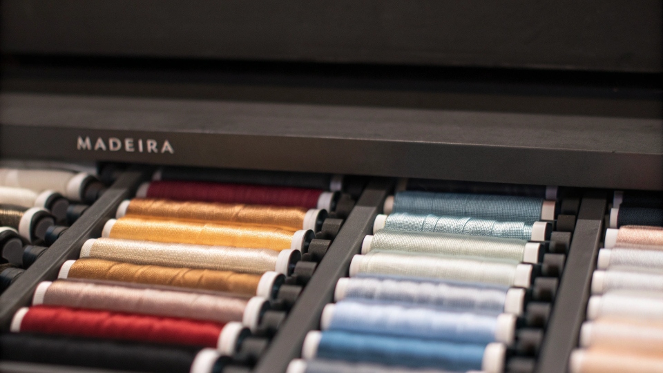 Colorfast Madeira Embroidery Thread A vibrant display of high-quality Madeira brand embroidery thread spools in various colors.