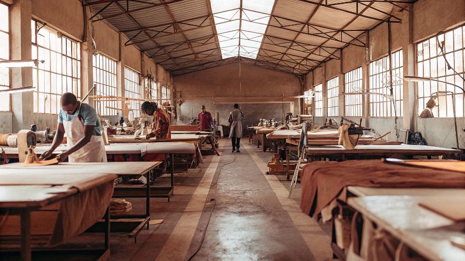In-House Jeans Production at DiZNEW Factory A wide-angle shot of the DiZNEW factory floor showing cutting tables, sewing lines, and washing machines under one roof.