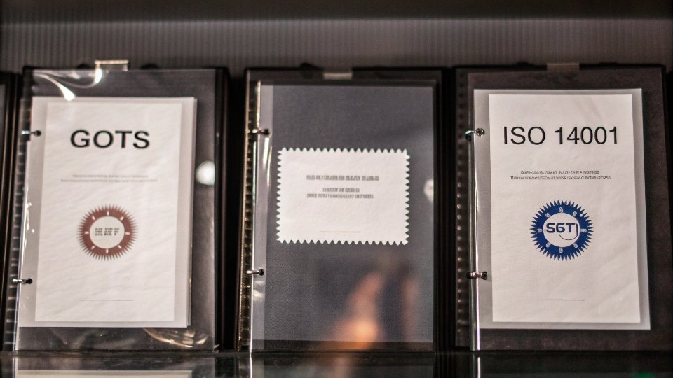 Documentation for Sustainable Jean Production A collection of official-looking documents, including a GOTS certificate, an ISO 14001 certificate, and a lab report