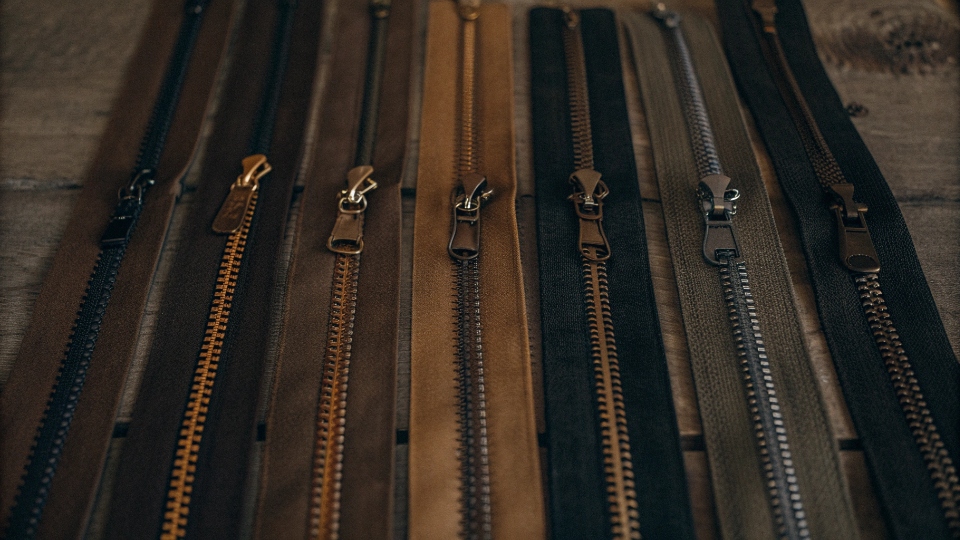 Available Zipper Lengths and Teeth Types An assortment of zippers in different lengths and with different teeth types like metal, nylon, and resin