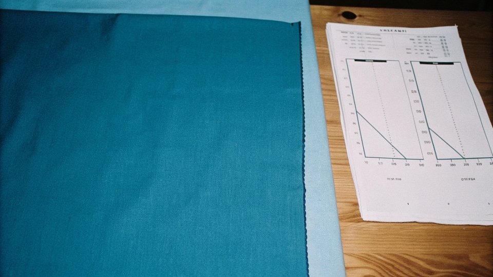 Verifying Jean Fabric Fiber Content and Weight A lab report showing fiber content analysis next to a fabric weight scale testing a denim swatch