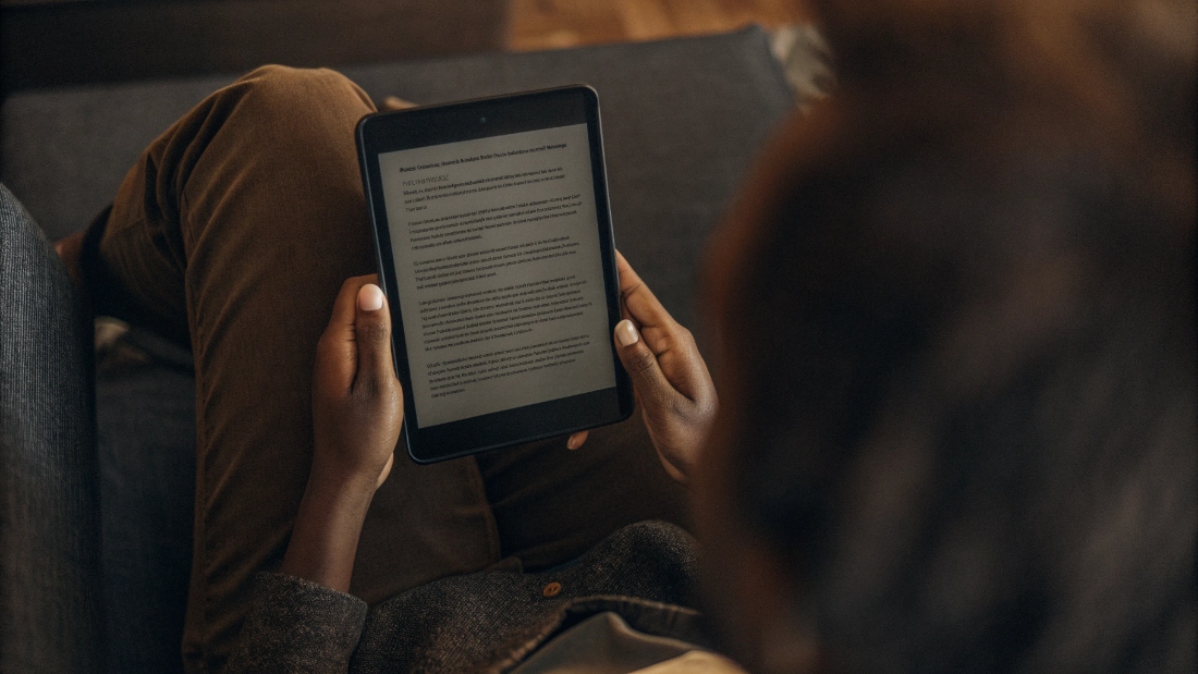 Sharing Recent Audit Summaries Transparently A person reviewing a social audit summary report on a tablet