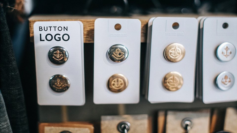 Warranty on Custom Jean Buttons and Rivets A collection of custom-branded buttons and rivets, showcasing unique logos and finishes, arranged to highlight quality.