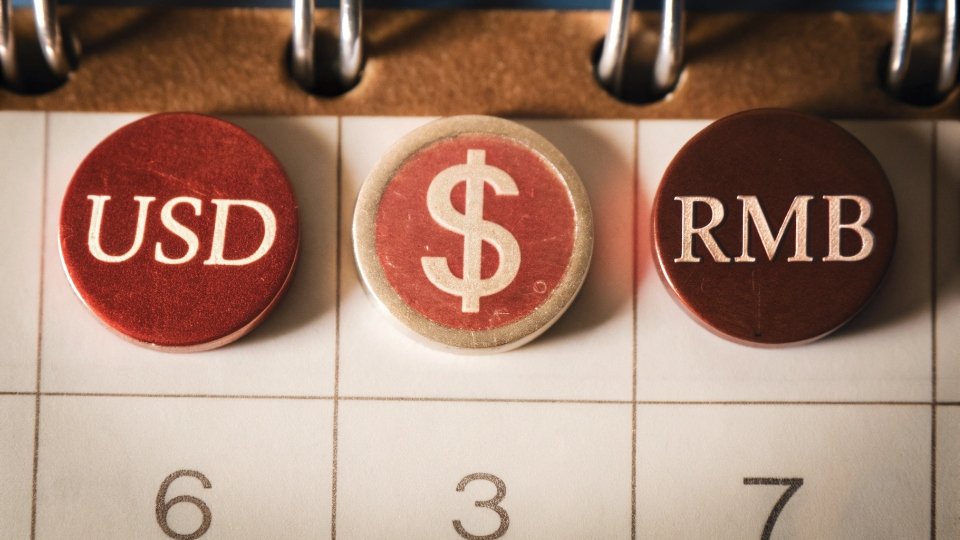 Forward-Dated Exchange Rates for Jean Orders A calendar page with a future date circled, with USD and RMB symbols next to it, signifying a locked-in rate.