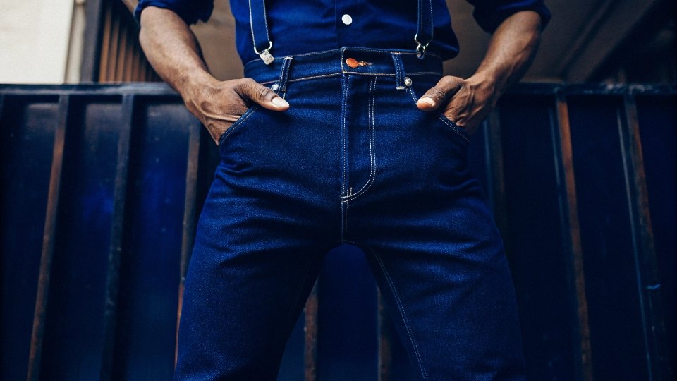 Men Wearing Button Fly Jeans A stylish man confidently wearing a pair of classic button fly jeans.