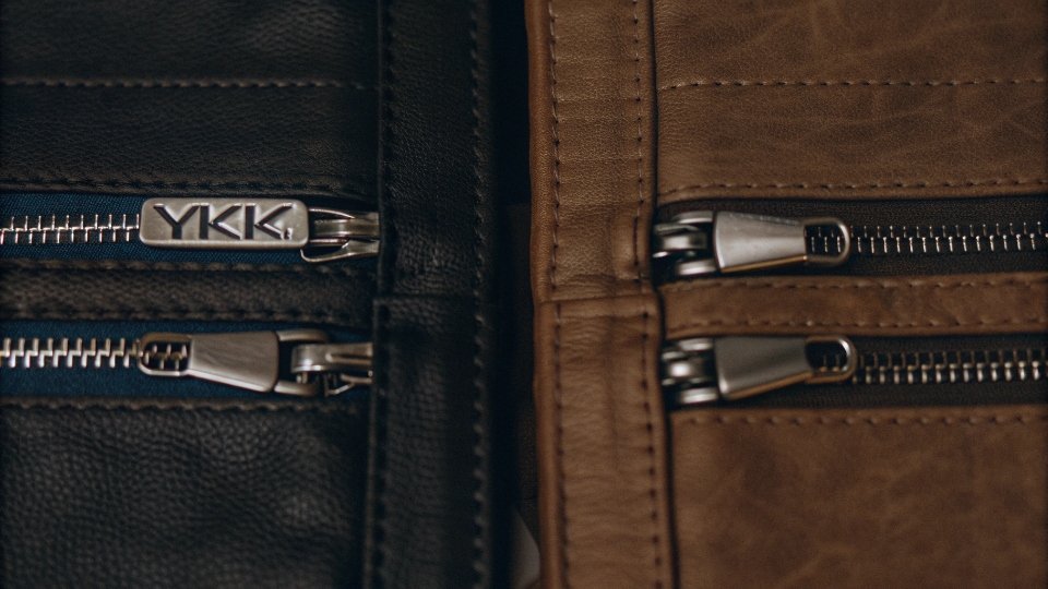 Branded vs. Generic Jean Zippers A side-by-side comparison of a YKK branded zipper and a high-quality generic zipper