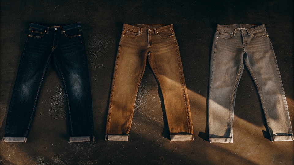 Mixing Jean Washes to Meet MOQ Three pairs of the same style of jeans shown side-by-side, each with a distinctly different wash—dark, medium stone wash, and light acid wash.
