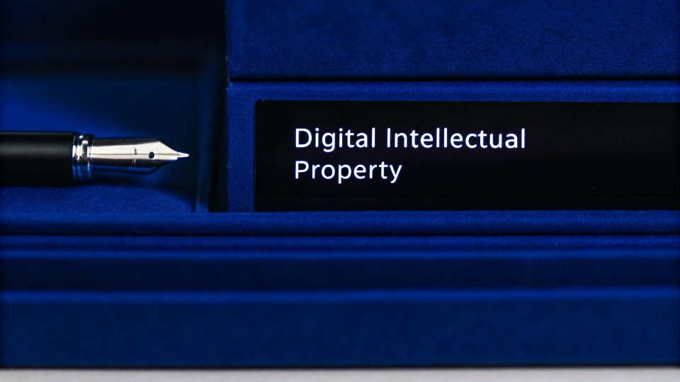 NDA Clauses for Digital Theft A close-up of a pen signing an NDA document with a section titled "Digital Intellectual Property" highlighted.