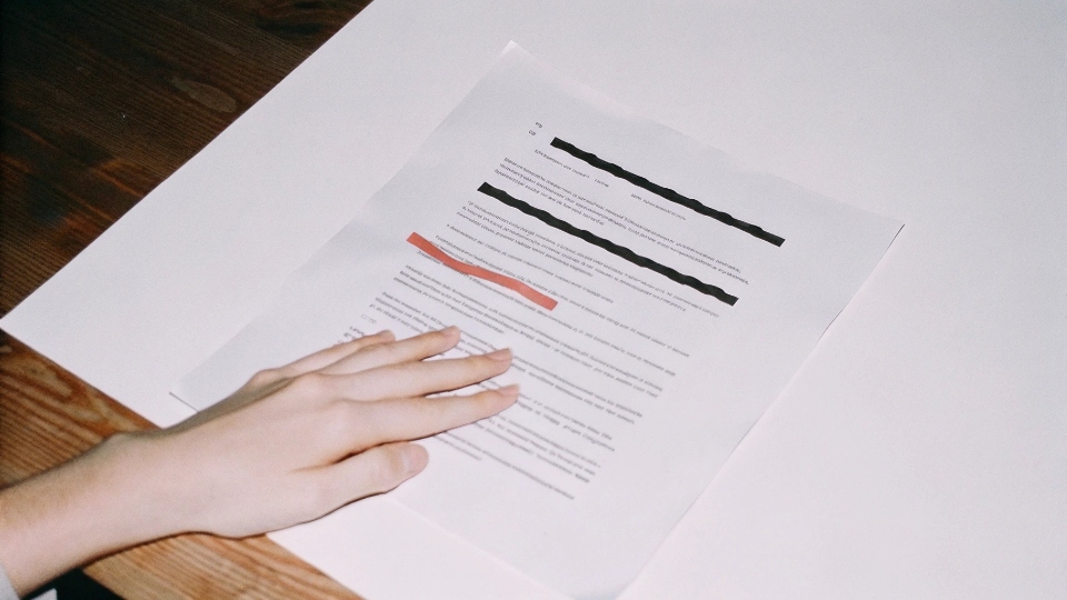 A close-up of a signed contract with a clause about late shipment penalties highlighted