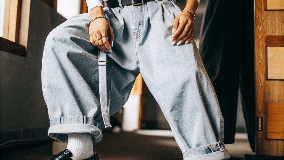 Styling Truly Oversized Pants A person wearing oversized baggy pants, cinched at the waist with a belt and neatly cuffed at the ankle.