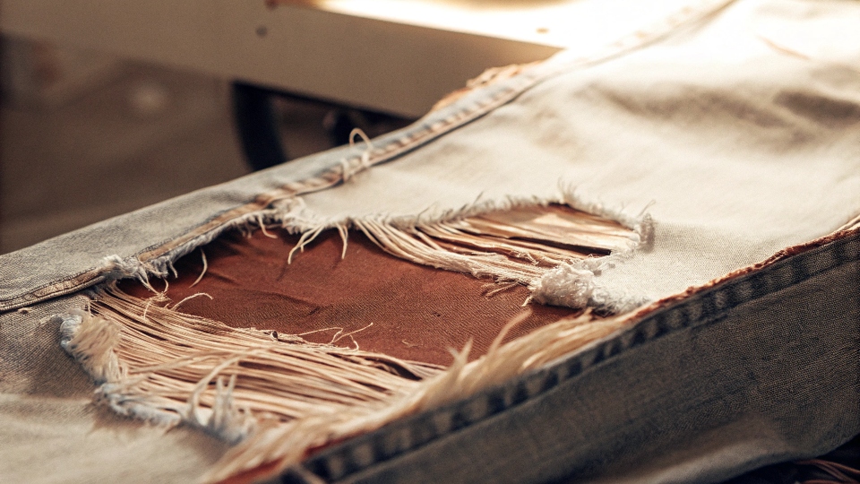 Denim Fabric After Abrasion A piece of regular denim fabric that has been shredded and torn after a simulated abrasion test.