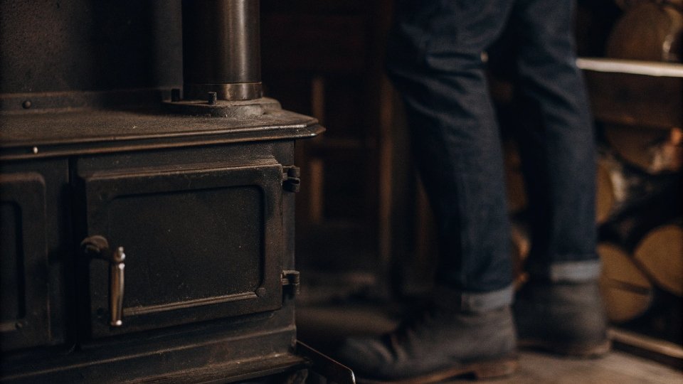 The Visual Origin of the Stove Pipe Jean Name A visual comparison of a vintage black metal stovepipe and the clean, straight leg line of a stove pipe jean.