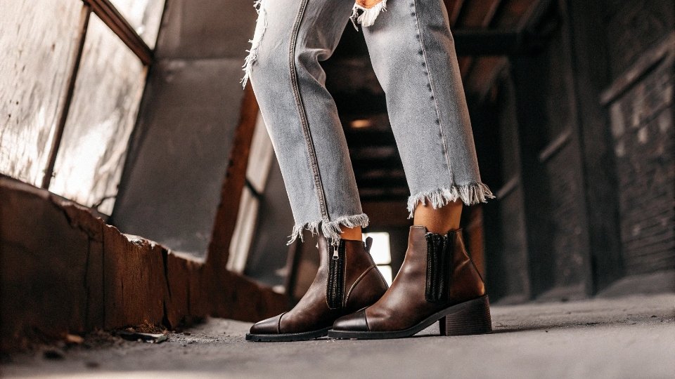 Raw Hem Baggy Jeans A pair of baggy jeans with a stylish, frayed raw hem, paired with ankle boots.