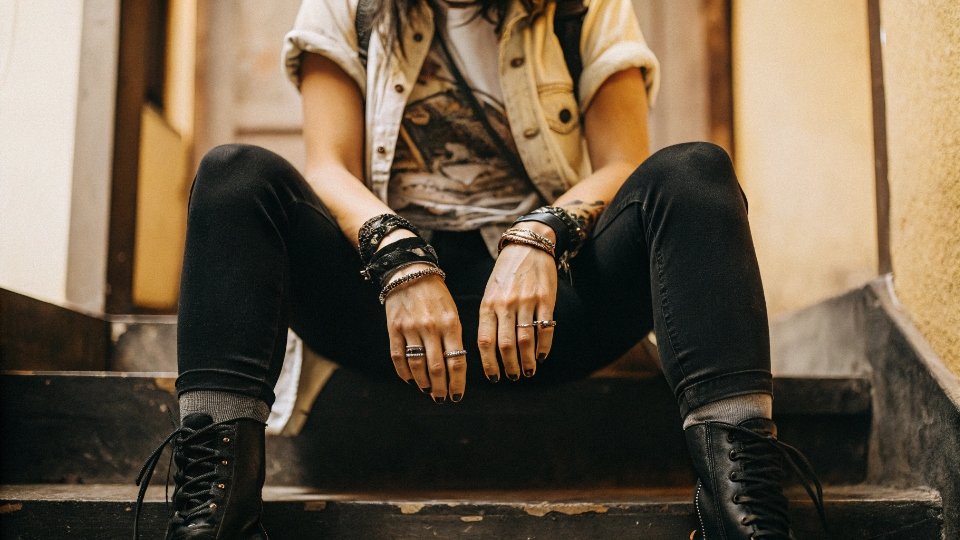 Gen Z Subculture Skinny Jeans Style A person dressed in an emo or indie rock style, featuring black skinny jeans, a band t-shirt, and heavy boots.