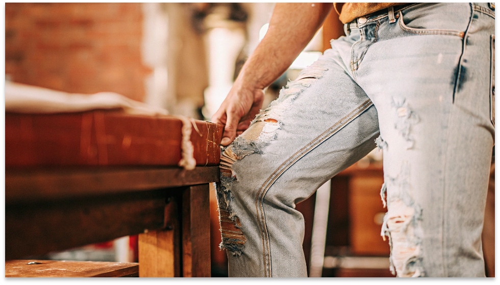 The Art of Amiri's Deconstruction A close-up shot of the intricate distressing and hand-painted details on a pair of Amiri jeans.