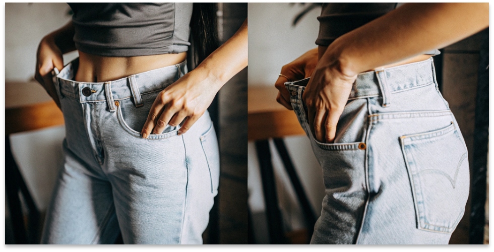 The Constant Struggle of Falling Jeans A person subtly pulling up the waistband of their skinny jeans.