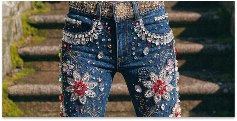 Ultra-Luxury Embellished Denim Close-up of a pair of jeans heavily embellished with crystals and intricate hand-embroidery.
