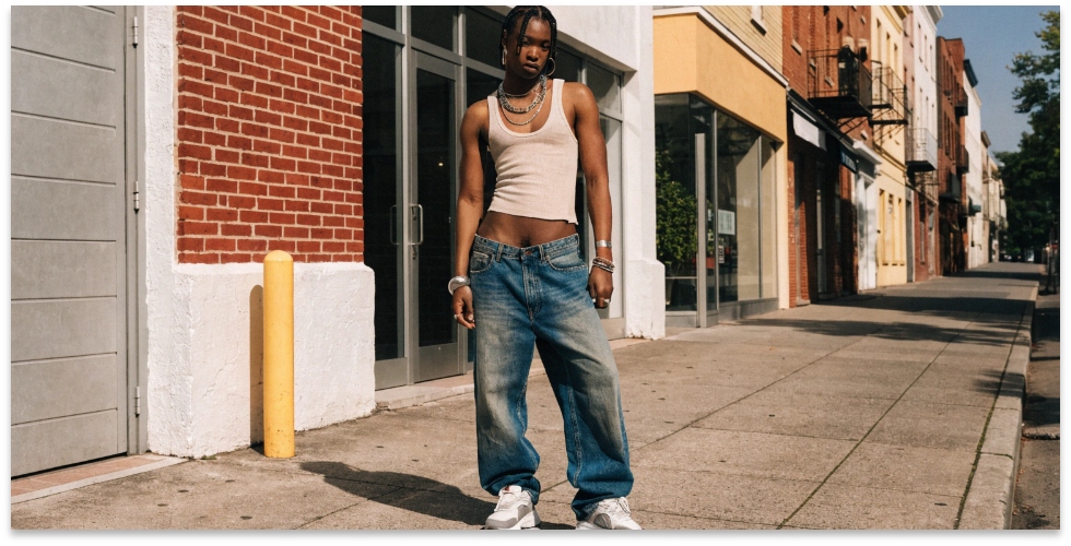 Example of low-cut jeans A person wearing a pair of low-cut jeans, showing the waistband sitting low on the hips.