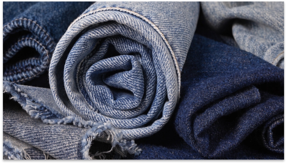 Various Types of Denim Fabric A close-up macro shot of different denim fabric swatches showing their weave and texture.